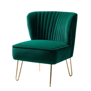 A dark green velvet chair with gold legs