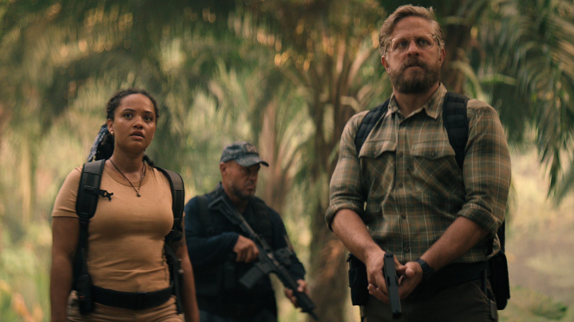 May standing in a forest with Tim, who's holding a handgun, in Monarch: Legacy of Monsters season 2 episode 10