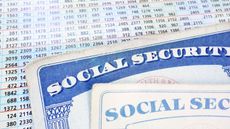 Social Security cards next to a table of numbers.