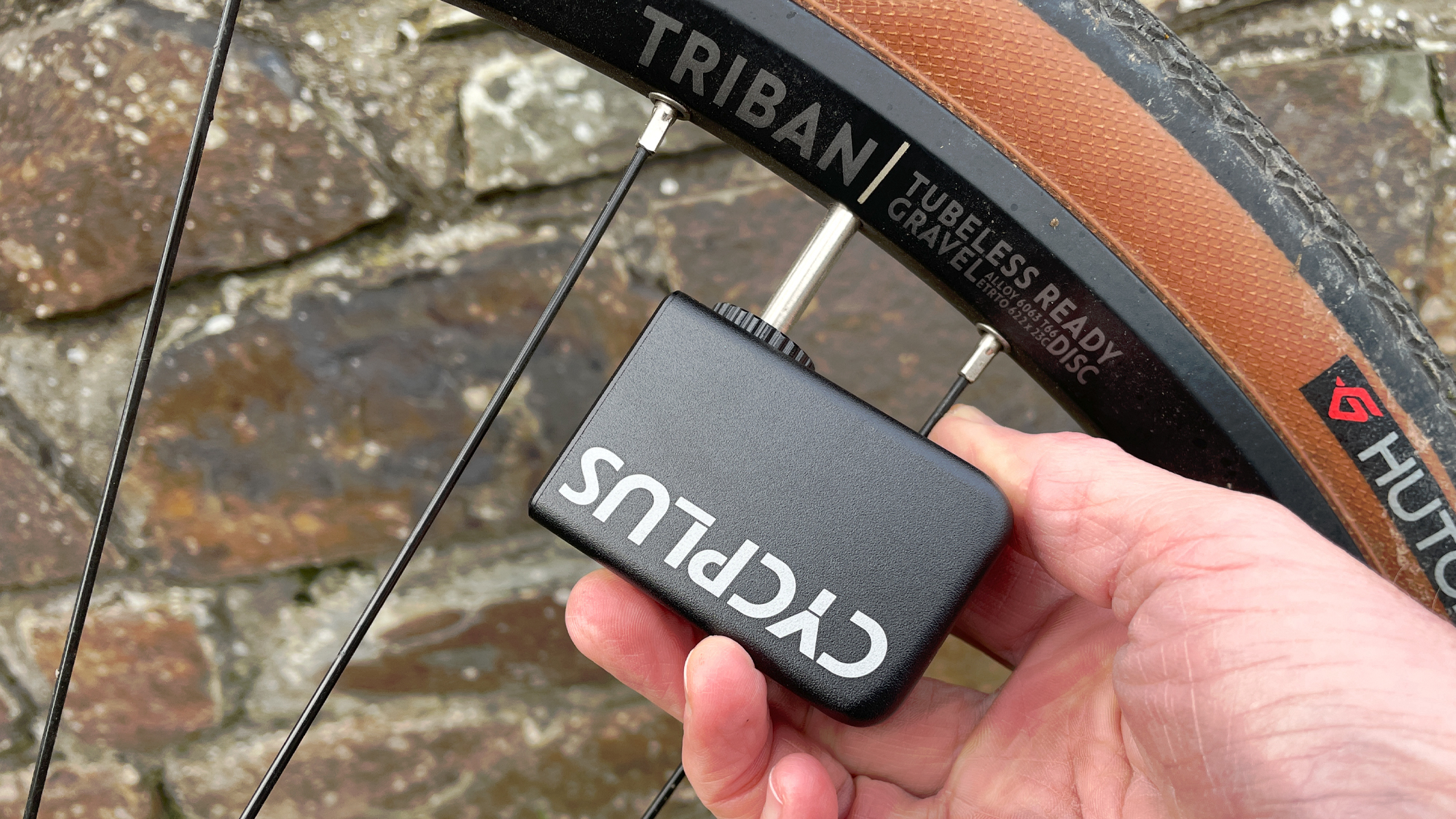 A Cycplus mini electric pump being used to inflate a gravel bike tyre