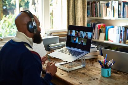 A man sits in his home office during a video call.. 