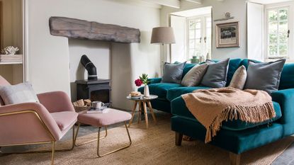 living room with fire place and sofa with cushions on brown throw