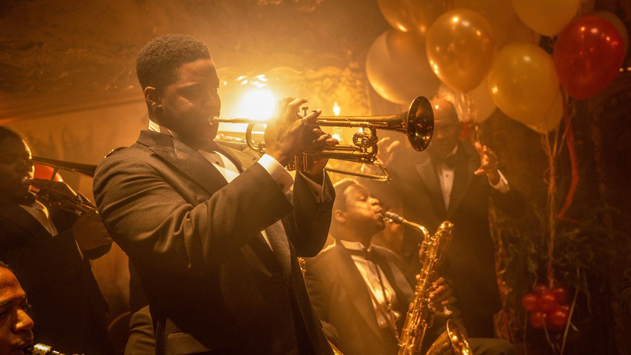 Jovan Adepo's Sidney Palmer plays the trumpet during a party in Paramount Pictures' Babylon