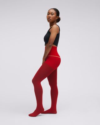 Sheertex model in black tank and red tights