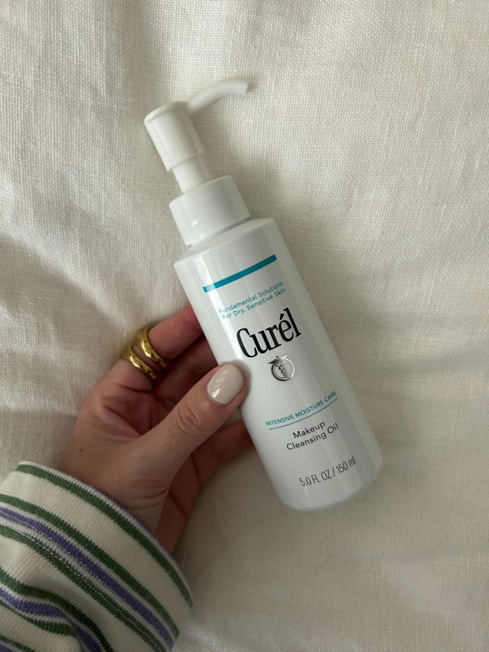 Junior beauty editor, Grace Lindsay, holding the Curel Makeup Cleansing Oil