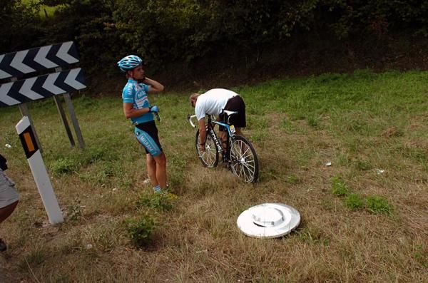 Linus Gerdemann (Team Milram) waits for his bicycle to be fixed following a crash.