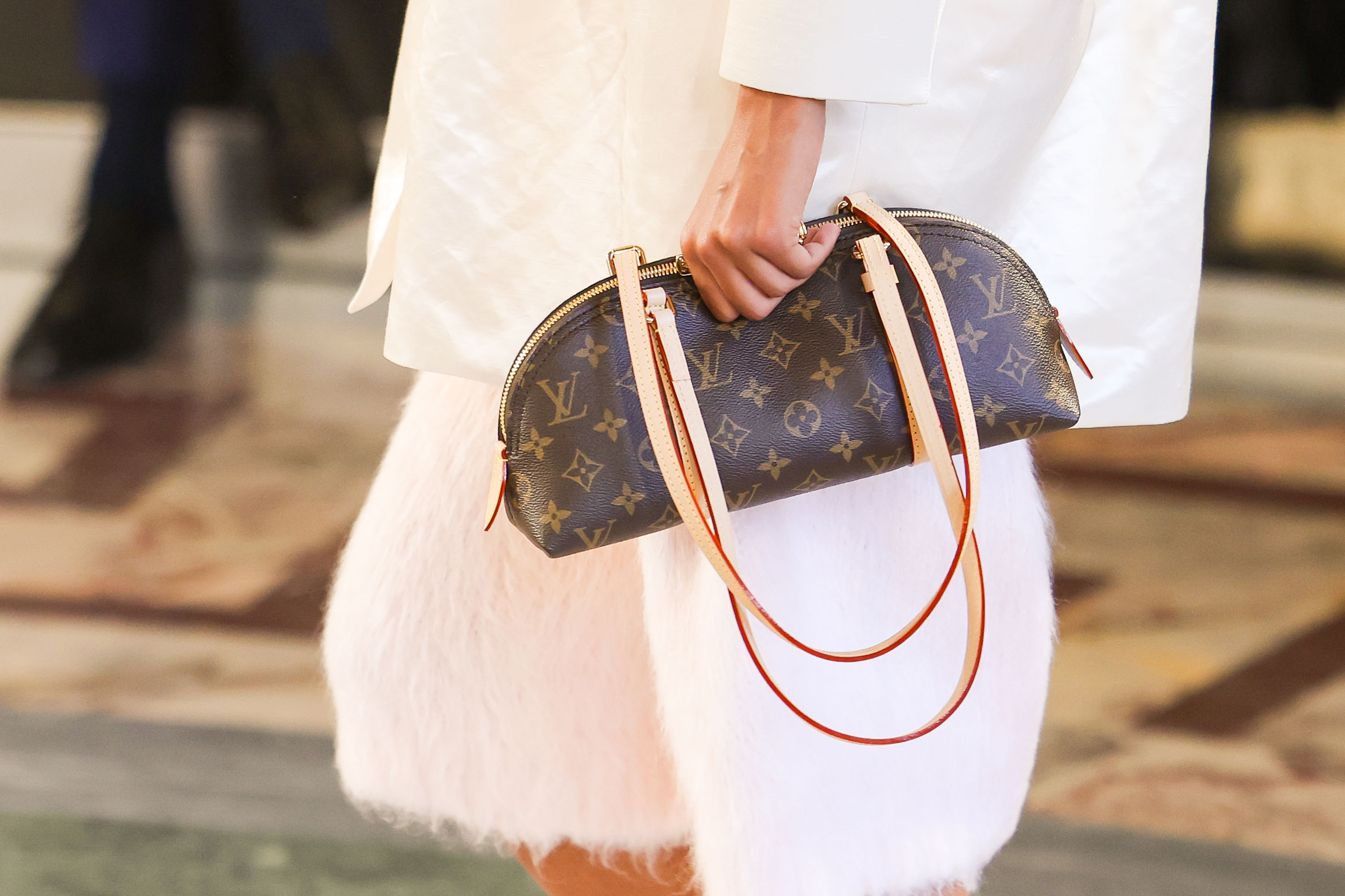 A model carries Emma Stone&#039;s Louis Vuitton bag on the Spring 2026 runway