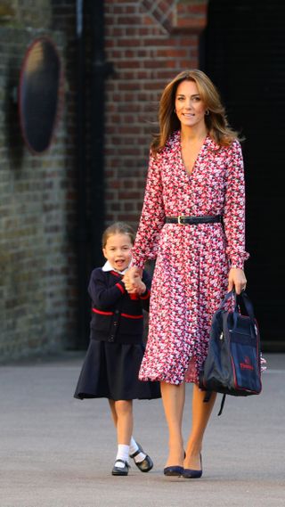 Kate Middleton in a red and white printed wrap dress