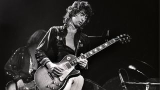 Jimmy Page performing on stage at the Seattle Coliseum, playing Gibson Les Paul guitar