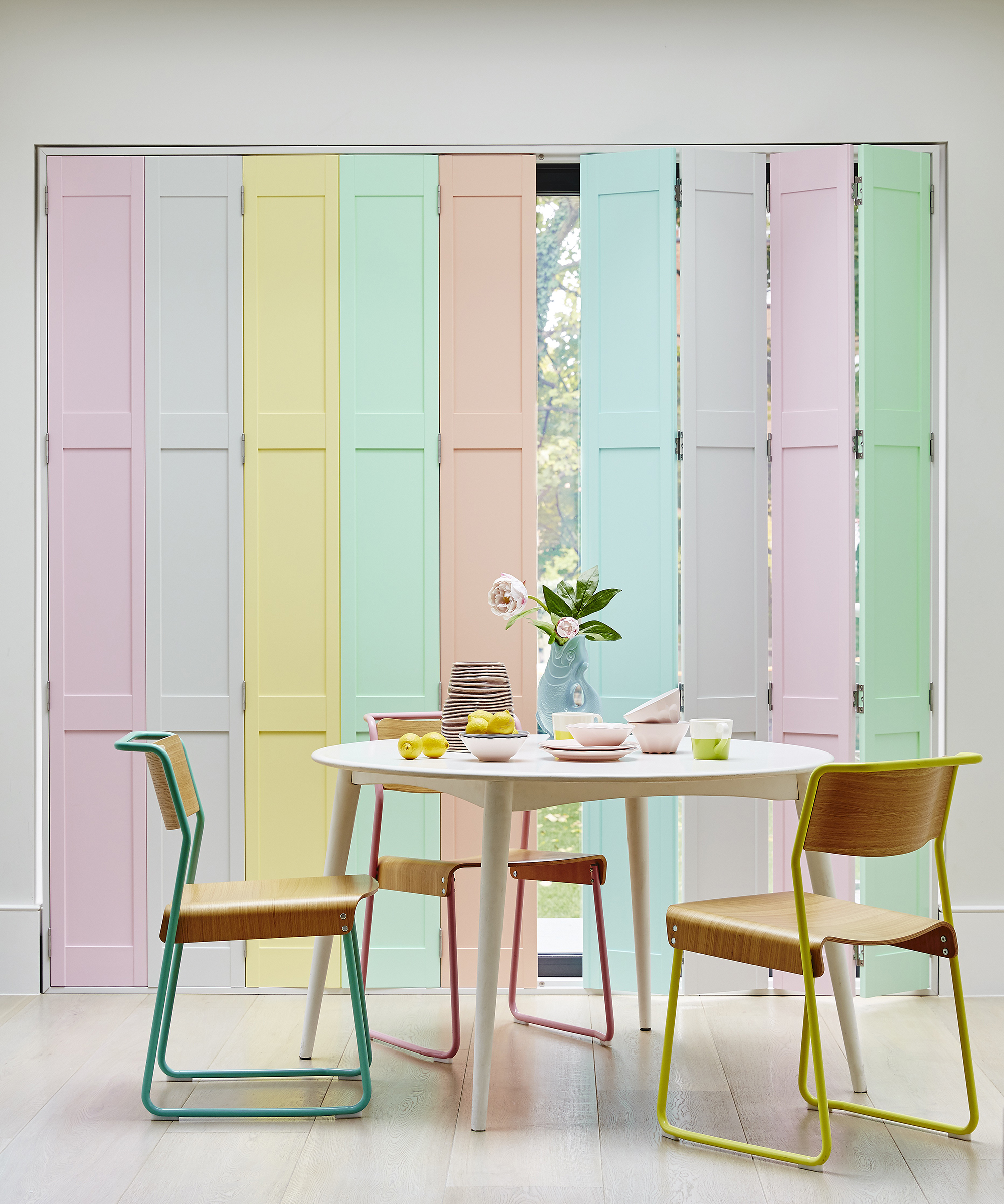 Pastel rainbow shutters in dining area