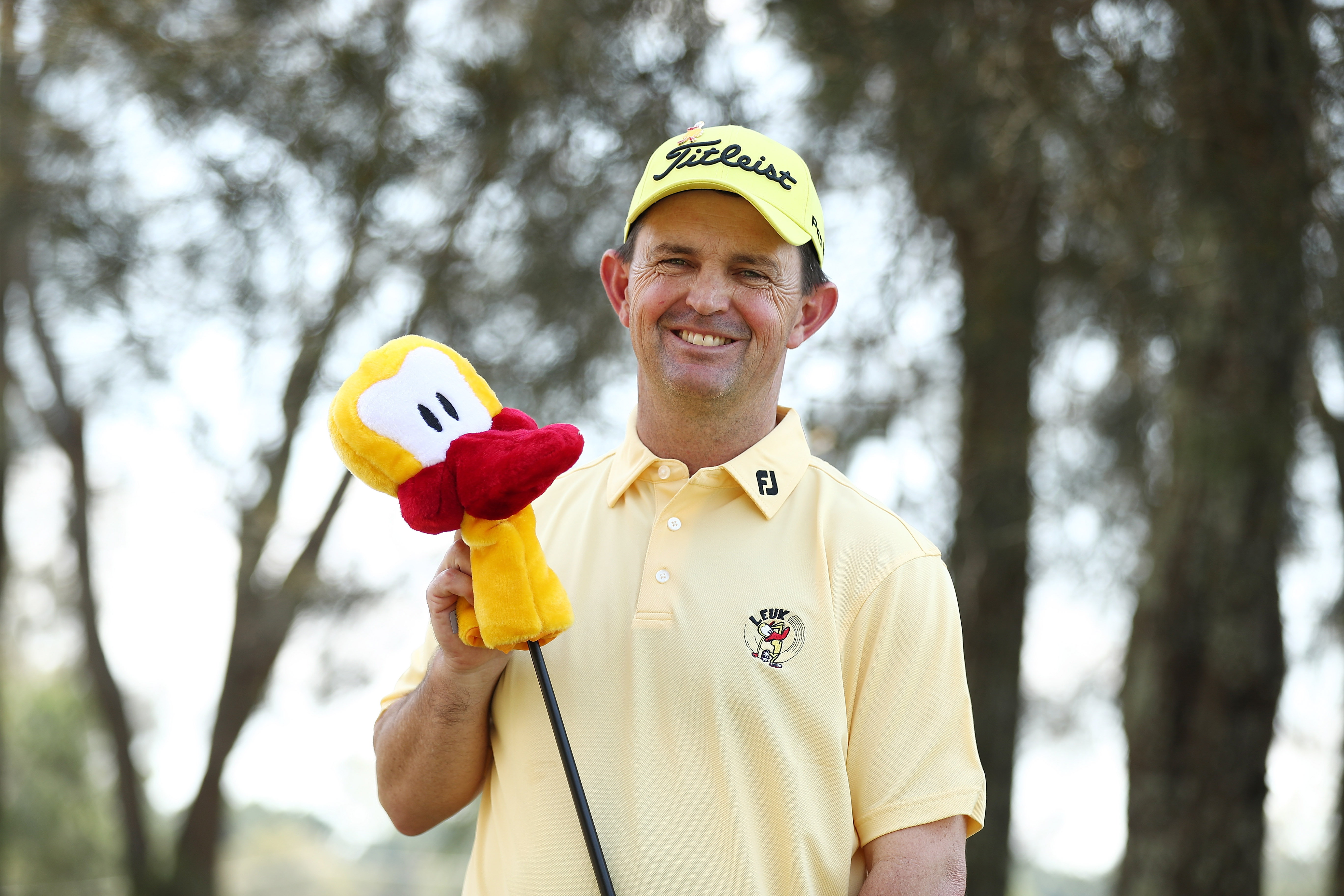 Greg Chalmers holds a Leuk the Duck mascot headcover