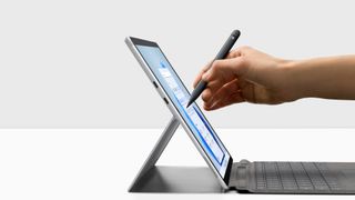 Microsoft Surface Pro X 2021 side profile with person drawing on the screen