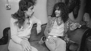 Brian Robertson and Rush’s Neil Peart talking on a sofa in the late 1970s