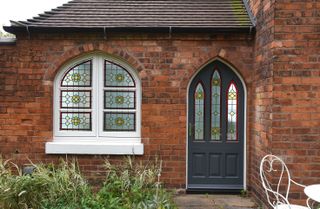 Exterior of home with stained glass windows and door detail