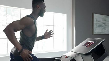 ProForm Pro 2000 review: fit young man running on a treadmill indoors
