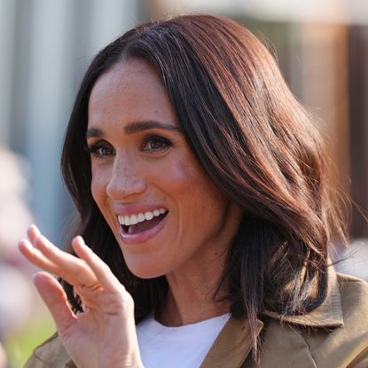 Meghan Markle smiling and waving