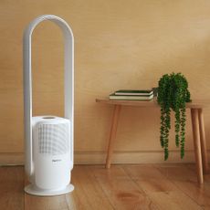  Pro Breeze bladeless tower fan and air purifier beside wooden bench with plant