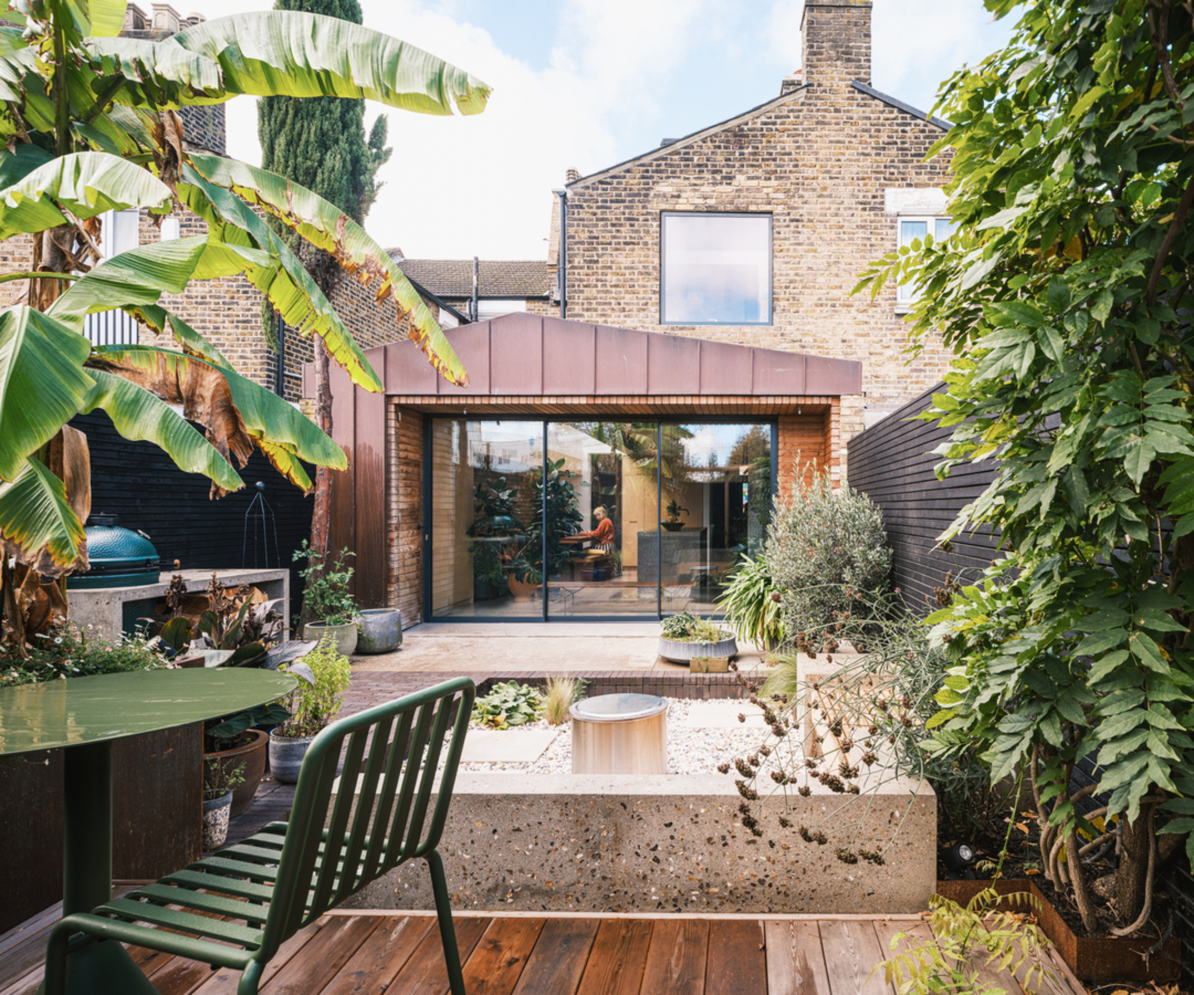 single storey extension on brick house with rear elevation featuring copper cladding
