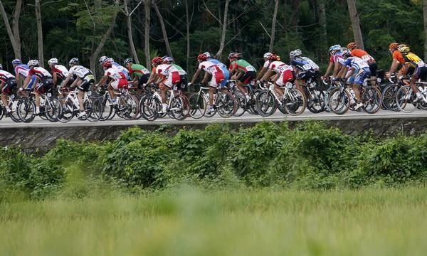 The peloton passes through some local country.