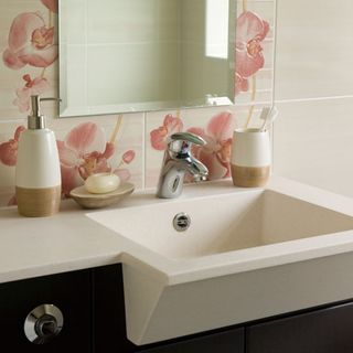 bathroom with mirror on wall and sink with tap