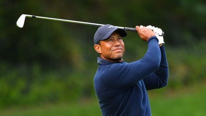 Tiger Woods hits an iron shot during R1 of the 2024 Genesis Invitational