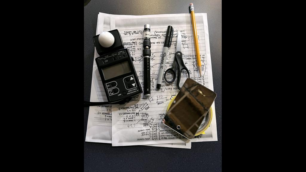 Tools of the trade: A light meter, laser pointer, pen, scissors, mirror and notes