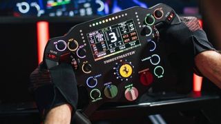 A promotional render of the Thrustmaster Ferrari 499P Centenary Winner Edition racing wheel.