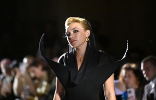 Florence Pugh on the Harris Reed runway wearing a black dress