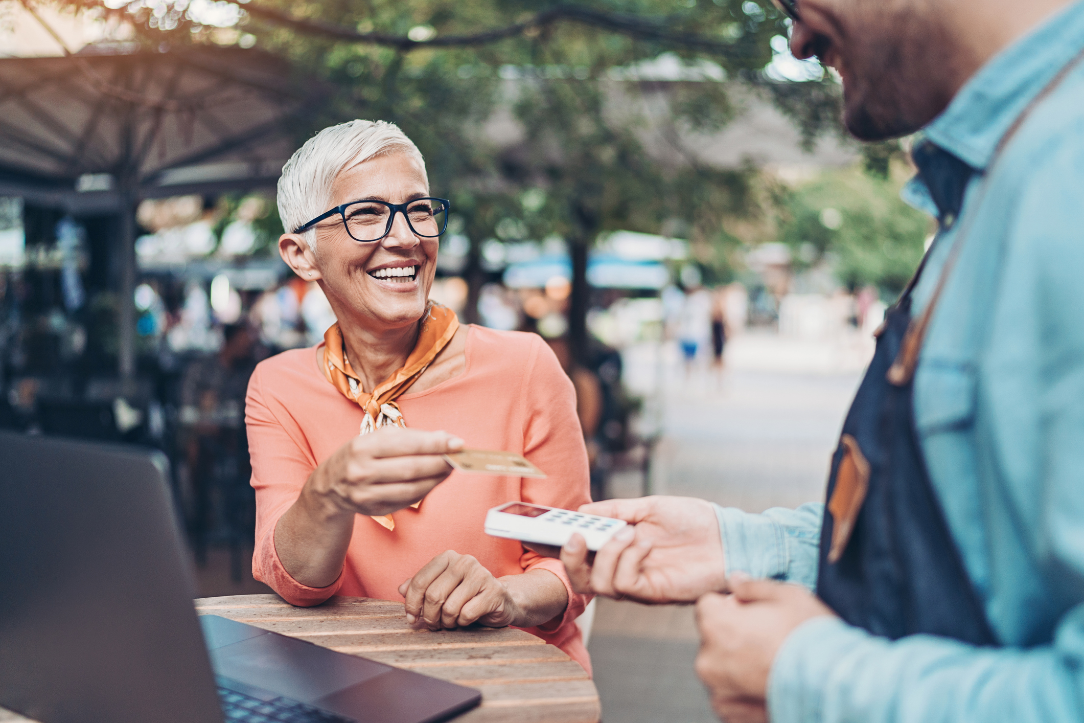 Woman paying for lunch with credit card