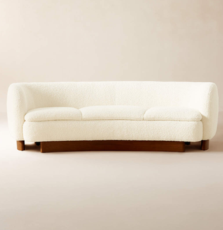 curved boucle couch with wooden legs/base