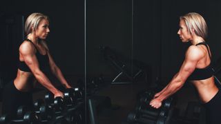 Woman ready to do hammer curls with dumbbells