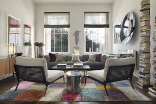 A symmetrical living room with a colourful rug
