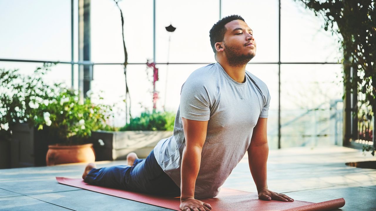 Man doing Yoga to get flexible