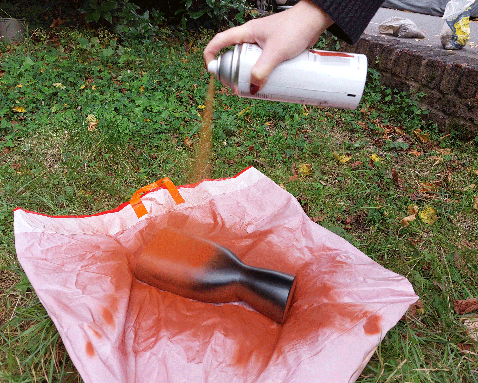 spray painting a vase