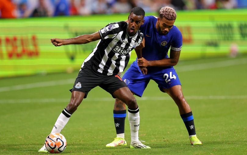 Alexander Isak shields the ball from Reece James