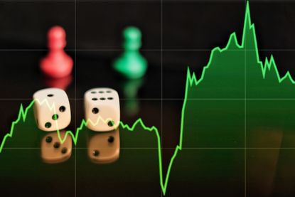 Two dice, red and green chess pieces and a shares graph showing a volatile financial market.