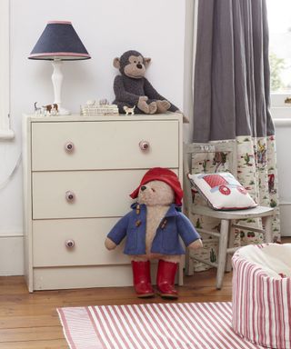 kids room with white walls vanity and wooden flooring