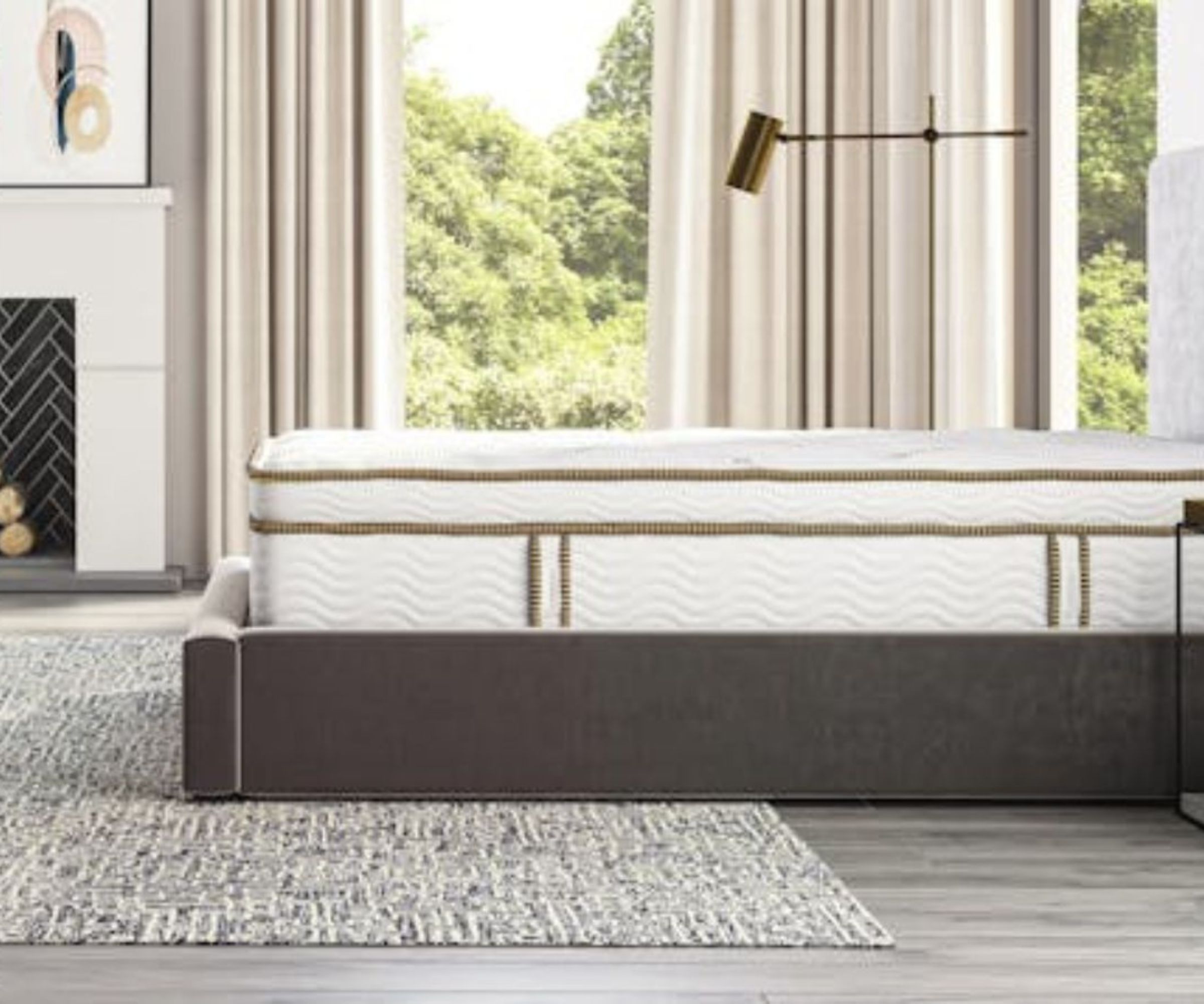 Side view of the Saatva Latex Hybrid on a bed frame against beige curtains.