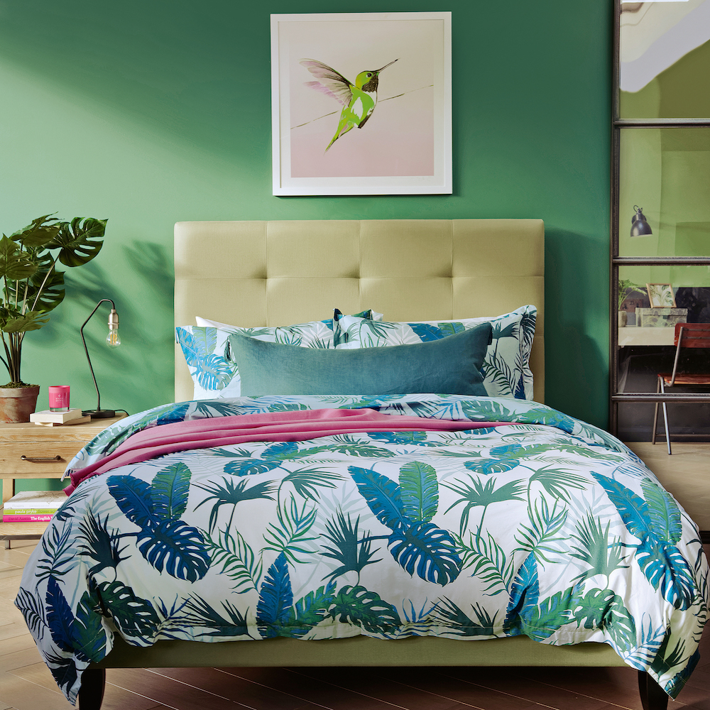 bedroom with wooden flooring and green wall