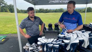 A golfer and fitter look at an iPad