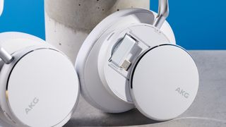 The AKG N9 Hybrid headphones photographed in front of a blue background.