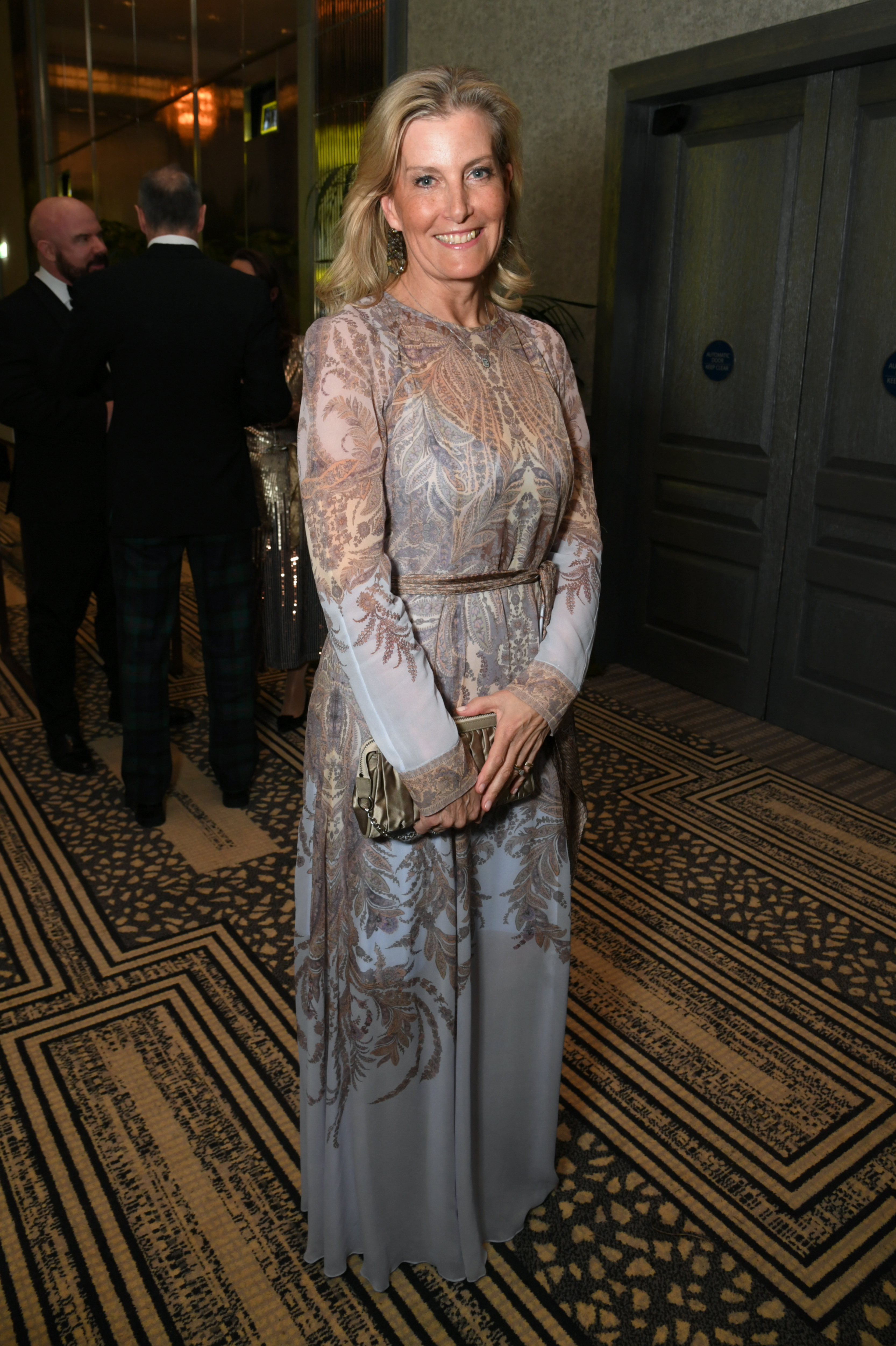 Duchess Sophie wearing a sheer blue paisley dress and smiling