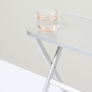 Silver table with glass on top
