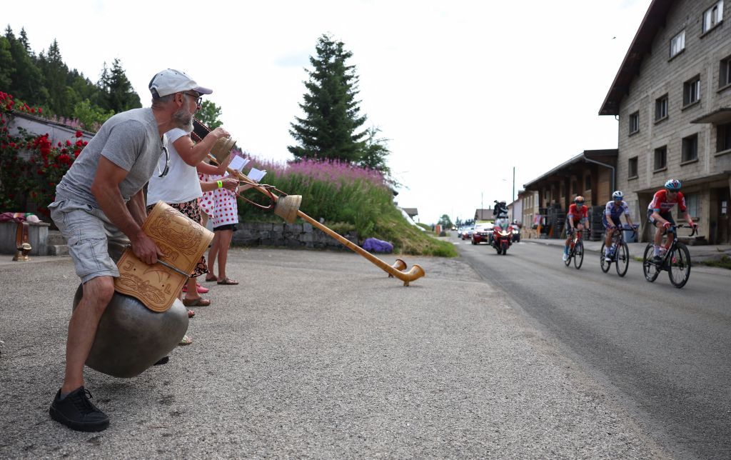 Spectators ring cow bells and play alpine horns or Swiss Alphorns as Lotto Soudal teams Belgian rider Frederik Frison R QuickStep Alpha Vinyl Teams Italian rider Mattia Cattaneo C and Bahrain Victorious teams British rider Fred Wright L cycle in a breakaway near the FrancoSwiss border during the 8th stage of the 109th edition of the of the Tour de France cycling race 1863 km between Dole in eastern France and Lausanne in Switzerland on July 9 2022 Photo by Thomas SAMSON AFP Photo by THOMAS SAMSONAFP via Getty Images