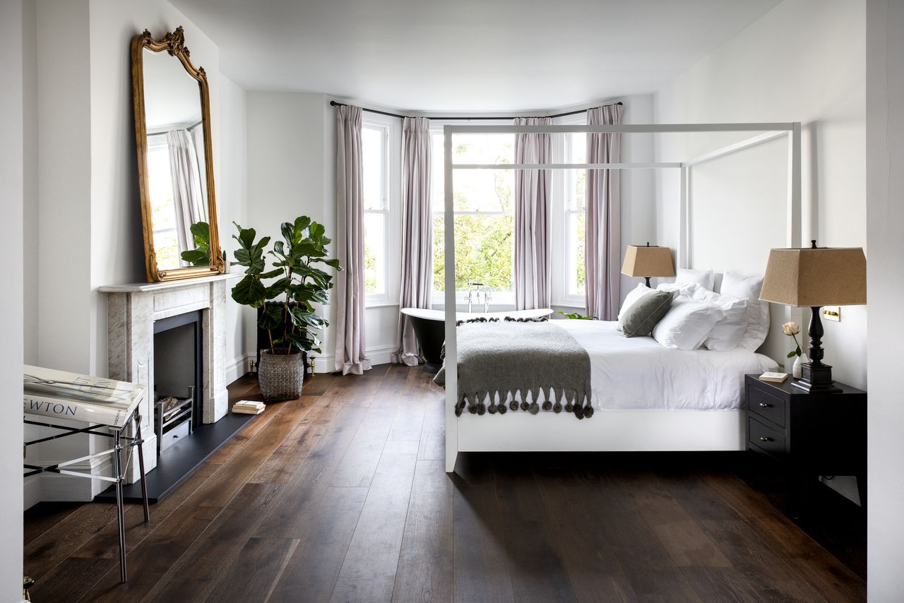 long curtains covering windows inside a neutral bedroom