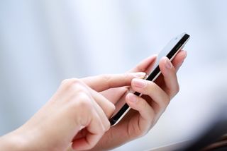 A woman sending a text message.