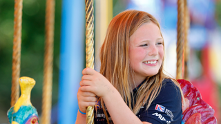 Mia Tindall rides on a carousel as she attends day 1 of the 2022 Festival of British Eventing at Gatcombe Park on August 5, 2022 in Stroud, England