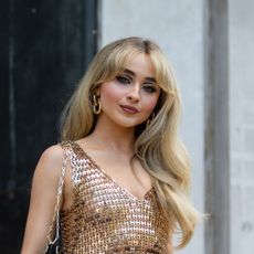 Sabrina Carpenter is seen wearing golden dress outside Paco Rabanne during Paris Fashion Week on July 03, 2022 in Paris, France