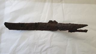 The iron sword was badly damaged in the fire that destroyed the monastery, and is badly corroded. But the assembly includes metal rings that were part of the scabbard that enclosed it.