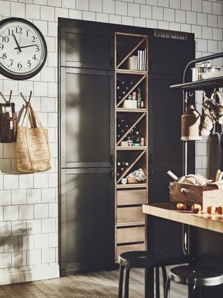 kitchen with dark wood doors and section for storing wine bottles by ikea